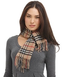 Luxuriously soft cashmere scarf in an all over check pattern is finished with fringe trim. Luxuriously soft cashmere scarf in an all over check pattern is finished with fringe trim.