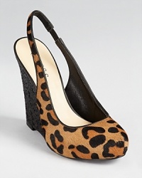 A glitter-covered wedge heel compliments leopard print haircalf on the GUESS Russo slingbacks. A glitter-covered wedge heel compliments leopard print haircalf on the GUESS Russo slingbacks.