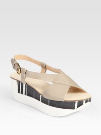 Two-tone, mixed-media platform wedge design accented by supple leather criss-cross straps. Rubber and wooden wedge, 2 (50mm)Rubber and wooden platform, 1½ (40mm)Compares to a ½ heel (15mm)Leather upperLeather liningRubber soleMade in Italy Two-tone, mixed-media platform wedge design accented by supple leather criss-cross straps. Rubber and wooden wedge, 2 (50mm)Rubber and wooden platform, 1½ (40mm)Compares to a ½ heel (15mm)Leather upperLeather liningRubber soleMade in Italy