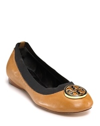 Leather, trimmed with elastic, is topped with gleaming Tory Burch logo medallion, a glam update for the classic ballet flat. Leather, trimmed with elastic, is topped with gleaming Tory Burch logo medallion, a glam update for the classic ballet flat.