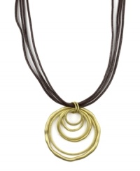 Let your sense of style come full circle. Jones New York's versatile pendant features graduated circles strung on a four-strand leather cord. Pendant and clasp crafted in gold tone mixed metal. Approximate length: 18 inches. Approximate drop: 2-1/2 inches. Let your sense of style come full circle. Jones New York's versatile pendant features graduated circles strung on a four-strand leather cord. Pendant and clasp crafted in gold tone mixed metal. Approximate length: 18 inches. Approximate drop: 2-1/2 inches.
