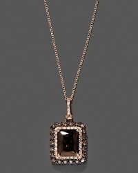 Diamonds and brown diamonds frame an emerald cut smoky quartz, set in 14K rose gold. Diamonds and brown diamonds frame an emerald cut smoky quartz, set in 14K rose gold.