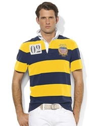 A classic rugby shirt, crafted from cotton jersey, is cut for a trim, modern fit and finished with vibrant stripes and bold country embroidery, celebrating Team USA's participation in the 2012 Olympic Games. A classic rugby shirt, crafted from cotton jersey, is cut for a trim, modern fit and finished with vibrant stripes and bold country embroidery, celebrating Team USA's participation in the 2012 Olympic Games.