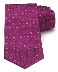 A silk tie adds distinction to your formal presentation. With a repeating pattern of Gancini logos, you'll also punch up your attire with the designer's signature flair. A silk tie adds distinction to your formal presentation. With a repeating pattern of Gancini logos, you'll also punch up your attire with the designer's signature flair.