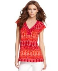 An ikat print and embroidered sequin embellishment at the neckline lends tribal-inspired chic to this top from Calvin Klein Jeans. An ikat print and embroidered sequin embellishment at the neckline lends tribal-inspired chic to this top from Calvin Klein Jeans.