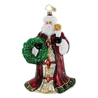 A regally dressed Santa holds a torch and festive wreath. A regally dressed Santa holds a torch and festive wreath.