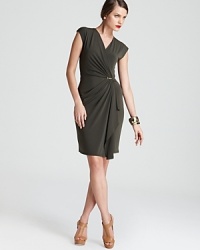 A soft, sophisticated MICHAEL Michael Kors faux-wrap dress has a chic crossover neckline that fastens with a signature golden clasp at the waist for flattering, feminine style. A soft, sophisticated MICHAEL Michael Kors faux-wrap dress has a chic crossover neckline that fastens with a signature golden clasp at the waist for flattering, feminine style.