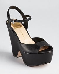 A cut-out wedge lends forward style to these chunky Dolce Vita platforms, rich in jet black leather. A cut-out wedge lends forward style to these chunky Dolce Vita platforms, rich in jet black leather.