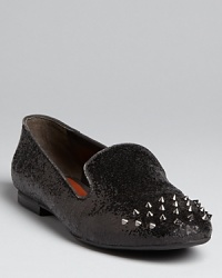 These SCHUTZ smoking flats add wow to a must-have silhouette, featuring glitter uppers covered with spiked studs. These SCHUTZ smoking flats add wow to a must-have silhouette, featuring glitter uppers covered with spiked studs.