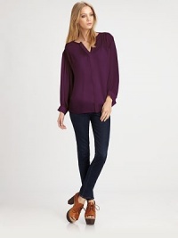 Loose-flowing silk top with long bishop sleeves, a hidden button front and hi-lo hem. V-neckHidden button frontLong bishop sleeves with buttoned cuffsHi-lo hemSilkDry cleanImportedModel shown is 5'10 (177cm) wearing US size Small. Loose-flowing silk top with long bishop sleeves, a hidden button front and hi-lo hem. V-neckHidden button frontLong bishop sleeves with buttoned cuffsHi-lo hemSilkDry cleanImportedModel shown is 5'10 (177cm) wearing US size Small.