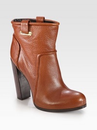 Towering, street-cool boot rendered in pebbled leather with shiny goldtone accents. Stacked heel, 4½ (115mm)Hidden platform, ¾ (20mm)Compares to a 3¾ heel (95mm)Leather upper with metal accentsLeather lining and solePadded insoleImported Towering, street-cool boot rendered in pebbled leather with shiny goldtone accents. Stacked heel, 4½ (115mm)Hidden platform, ¾ (20mm)Compares to a 3¾ heel (95mm)Leather upper with metal accentsLeather lining and solePadded insoleImported