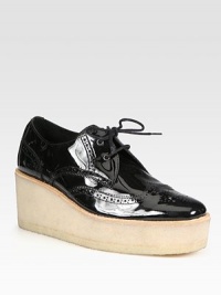 Patent leather design with classic perforated detailing rests on an elevated platform. Rubber wedge, 2¾ (70mm)Rubber platform, 1½ (40mm)Compares to a 1¼ heel (30mm)Patent leather upperLeather liningRubber solePadded insoleMade in Italy Patent leather design with classic perforated detailing rests on an elevated platform. Rubber wedge, 2¾ (70mm)Rubber platform, 1½ (40mm)Compares to a 1¼ heel (30mm)Patent leather upperLeather liningRubber solePadded insoleMade in Italy