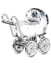 A fantastic gift for the new parents! In multifaceted cut-crystal, Swarovski has designed a fanciful little baby carriage. Decorative metal accents surround the figurine and the wheels actually turn. A fantastic gift for the new parents! In multifaceted cut-crystal, Swarovski has designed a fanciful little baby carriage. Decorative metal accents surround the figurine and the wheels actually turn.
