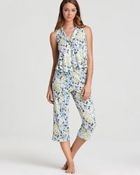A colorful floral print pajama set with a sleeveless top and matching wide leg capri pants. A colorful floral print pajama set with a sleeveless top and matching wide leg capri pants.