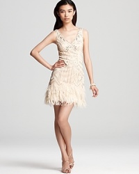 Fringed feathers detail the skirt of this Sue Wong dress, crafted in a sleeveless, v neck silhouette and dressed up with beaded details. Fringed feathers detail the skirt of this Sue Wong dress, crafted in a sleeveless, v neck silhouette and dressed up with beaded details.