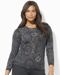 A lustrous silk-and-cashmere construction lends sultry appeal to a classic crewneck sweater. A lustrous silk-and-cashmere construction lends sultry appeal to a classic crewneck sweater.