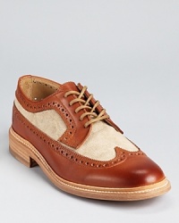 Frye taps into a classic look with this smart wingtip oxford, further embellished with contrasting canvas panels, leather laces and a wide, stitched welt. Frye taps into a classic look with this smart wingtip oxford, further embellished with contrasting canvas panels, leather laces and a wide, stitched welt.