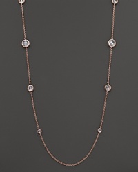 Ice-like drops of clear, bezel-set faceted quartz stud a chain of rose gold.
