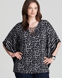 Enlivened by a graphic rush of animal prints, this MICHAEL Michael Kors Plus top lends exotic inspiration to your everyday look. Tame the style with sleek denim for a roaring fashion statement. Enlivened by a graphic rush of animal prints, this MICHAEL Michael Kors Plus top lends exotic inspiration to your everyday look. Tame the style with sleek denim for a roaring fashion statement.