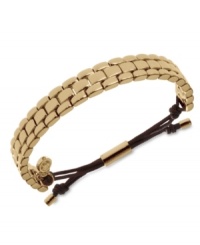 Watch out for sleek style. This adjustable bracelet from Michael Kors sports a linked, watch-inspired design. Adjustable with silk cord. Crafted in gold tone mixed metal. Approximate diameter: 2 to 2-1/2 inches. Approximate width: 1/3 inch. Watch out for sleek style. This adjustable bracelet from Michael Kors sports a linked, watch-inspired design. Adjustable with silk cord. Crafted in gold tone mixed metal. Approximate diameter: 2 to 2-1/2 inches. Approximate width: 1/3 inch.
