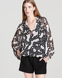 Cut from billowing silk chiffon, this DIANE von FURSTENBERG top touts a bold chain print for retro appeal. Cut from billowing silk chiffon, this DIANE von FURSTENBERG top touts a bold chain print for retro appeal.