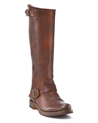 Rustic tall slouchy leather boots in a pull-on style. Adjustable buckle straps at ankle and top. Round toe and 1 raw stacked heel. Banded logo on side of heel. Leather lining and leather sole with rubber tread inset. Rustic tall slouchy leather boots in a pull-on style. Adjustable buckle straps at ankle and top. Round toe and 1 raw stacked heel. Banded logo on side of heel. Leather lining and leather sole with rubber tread inset.
