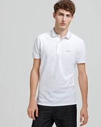 A stripe trim at the collar adds a hint of graphic appeal to the Burberry Adler polo. A stripe trim at the collar adds a hint of graphic appeal to the Burberry Adler polo.