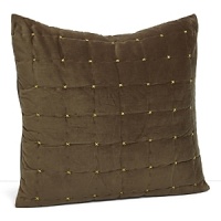 A rich, soft velvet coverlet and shams exude luxury. Light green cross stitches highlight the olive quilted grid pattern.