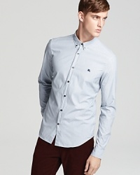 A subtle striped pattern distinguishes this essential button-front shirt from Burberry Brit. A subtle striped pattern distinguishes this essential button-front shirt from Burberry Brit.
