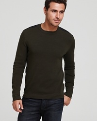 A Victorinox crewneck sweater features shoulder and elbow patches, reinforcing a refined military-inspired look. A Victorinox crewneck sweater features shoulder and elbow patches, reinforcing a refined military-inspired look.