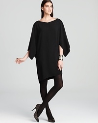 Bring your wardrobe back to black in this Elie Tahari dress, touting shirred sleeves and an asymmetrical silhouette for an effortlessly edgy style. Bring your wardrobe back to black in this Elie Tahari dress, touting shirred sleeves and an asymmetrical silhouette for an effortlessly edgy style.
