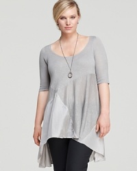 Subtle color blocking and an asymmetric hemline lend modern appeal to this Eileen Fisher Plus tunic. Balance the breezy silhouette with sleek separates for effortless sophistication. Subtle color blocking and an asymmetric hemline lend modern appeal to this Eileen Fisher Plus tunic. Balance the breezy silhouette with sleek separates for effortless sophistication.