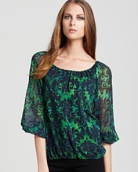 A lush floral print invigorates this peasant-style Alice + Olivia top, rendered in pure silk, with the essence of fall. A lush floral print invigorates this peasant-style Alice + Olivia top, rendered in pure silk, with the essence of fall.