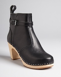 Swedish Hasbeens adds a bit of equestrian detail to signature clog booties with buckled ankle details and pull tabs. Lighweight and stylish, they're a comfort-meets-cool choice. Swedish Hasbeens adds a bit of equestrian detail to signature clog booties with buckled ankle details and pull tabs. Lighweight and stylish, they're a comfort-meets-cool choice.