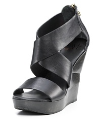 Modern leather wood wedge sandals with thick criss-crossing straps. Modern leather wood wedge sandals with thick criss-crossing straps.