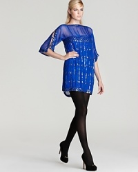 Mod for now, this sparking sequin dress moves the '60s flared sleeve and shift silhouette to the 21st century with a hard-soft edge: sheer panels, geometric motif. Mod for now, this sparking sequin dress moves the '60s flared sleeve and shift silhouette to the 21st century with a hard-soft edge: sheer panels, geometric motif.