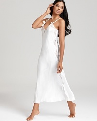 A gorgeous long gown with lace trim and bow accents. A gorgeous long gown with lace trim and bow accents.
