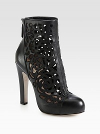 Intricate cutouts define this trend-forward ankle boot with a powerful heel and hidden platform. Self-covered heel, 5¼ (130mm)Hidden platform, 1 (25mm)Compares to a 4¼ heel (110mm)Leather upperBack zipLeather lining and solePadded insoleMade in Italy Intricate cutouts define this trend-forward ankle boot with a powerful heel and hidden platform. Self-covered heel, 5¼ (130mm)Hidden platform, 1 (25mm)Compares to a 4¼ heel (110mm)Leather upperBack zipLeather lining and solePadded insoleMade in Italy