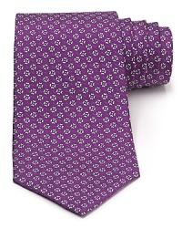 A silk tie adds distinction and flair to your formal presentation. With a repeating pattern of flowers, you'll also punch up your attire with a bit of handsome elegance. A silk tie adds distinction and flair to your formal presentation. With a repeating pattern of flowers, you'll also punch up your attire with a bit of handsome elegance.