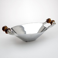 This hand-crafted bowl features dark amber glass handles with exquisitely hand-polished metal. This hand-crafted bowl features dark amber glass handles with exquisitely hand-polished metal.
