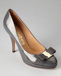 Salvatore Ferragamo creates the perfect day-to-night pumps in a modern, platform silhouette in chic patent with signature gold tone bow accents. Salvatore Ferragamo creates the perfect day-to-night pumps in a modern, platform silhouette in chic patent with signature gold tone bow accents.