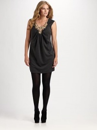 A dazzling jeweled neckline gives this simply chic style an air of glamour. V-neckSleevelessJeweled bib frontGathered frontAbout 20 from natural waist75% rayon/16% nylon/9% spandexDry cleanMade in USA A dazzling jeweled neckline gives this simply chic style an air of glamour. V-neckSleevelessJeweled bib frontGathered frontAbout 20 from natural waist75% rayon/16% nylon/9% spandexDry cleanMade in USA