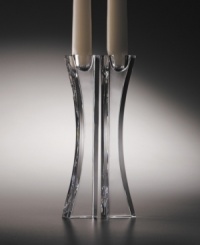 These crystal candlesticks designed by Karim Rashid for Nambé are the perfect accent for the sophisticated home. Clear crystal and an asymmetrical shape combine for modern elegance. Candles not included. These crystal candlesticks designed by Karim Rashid for Nambé are the perfect accent for the sophisticated home. Clear crystal and an asymmetrical shape combine for modern elegance. Candles not included.