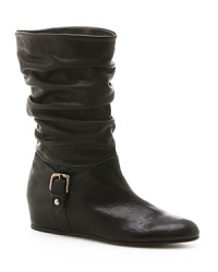 This cross between a slouch and moto boot has resulted in a distinctive, fashionable hybrid, from always-inventive Stuart Weitzman. This cross between a slouch and moto boot has resulted in a distinctive, fashionable hybrid, from always-inventive Stuart Weitzman.