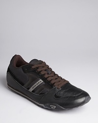 A melange of synthetic leather and suede sets apart this striking sporty design from Diesel, a versatile sneaker that complements a variety of shorts, jeans and pants. A melange of synthetic leather and suede sets apart this striking sporty design from Diesel, a versatile sneaker that complements a variety of shorts, jeans and pants.