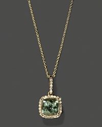 Diamonds frame a green amethyst, set in 14K white gold. Diamonds frame a green amethyst, set in 14K white gold.