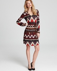 Channel jet-setting style in this Velvet by Graham & Spencer dress, imbued with an eclectic print and finished with a waist-defining tie. Channel jet-setting style in this Velvet by Graham & Spencer dress, imbued with an eclectic print and finished with a waist-defining tie.