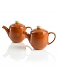 Two little teapots pour salt and pepper in this charming terracotta-colored set to match Denby's Fire dinnerware collection. Two little teapots pour salt and pepper in this charming terracotta-colored set to match Denby's Fire dinnerware collection.