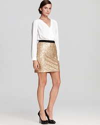 A mixed-media sensation, this DKNY dress marries a fluid blouse with a sequin skirt for a silhouette designed to draw stares. Slip it on and step into the spotlight.