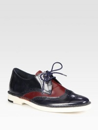 Classically perforated, Italian leather oxford has a modern, two-tone design, lace-up front and slight heel. Stacked heel, 1 (25mm)Leather upperLeather lining and solePadded insoleMade in Italy Classically perforated, Italian leather oxford has a modern, two-tone design, lace-up front and slight heel. Stacked heel, 1 (25mm)Leather upperLeather lining and solePadded insoleMade in Italy